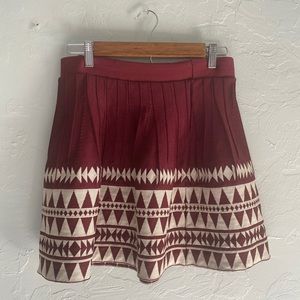 Red & cream patterned skirt.